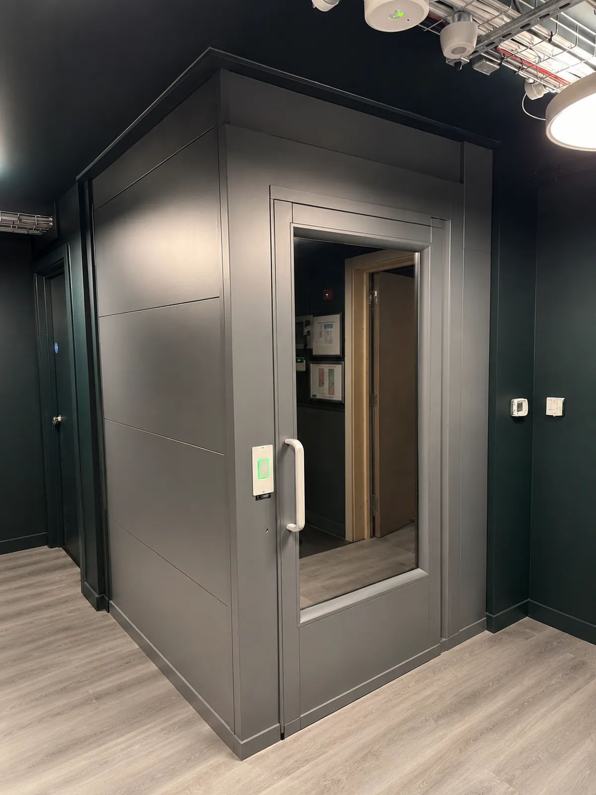 The anthracite grey lift at The Gym, Leeds, set into the dark gym interior