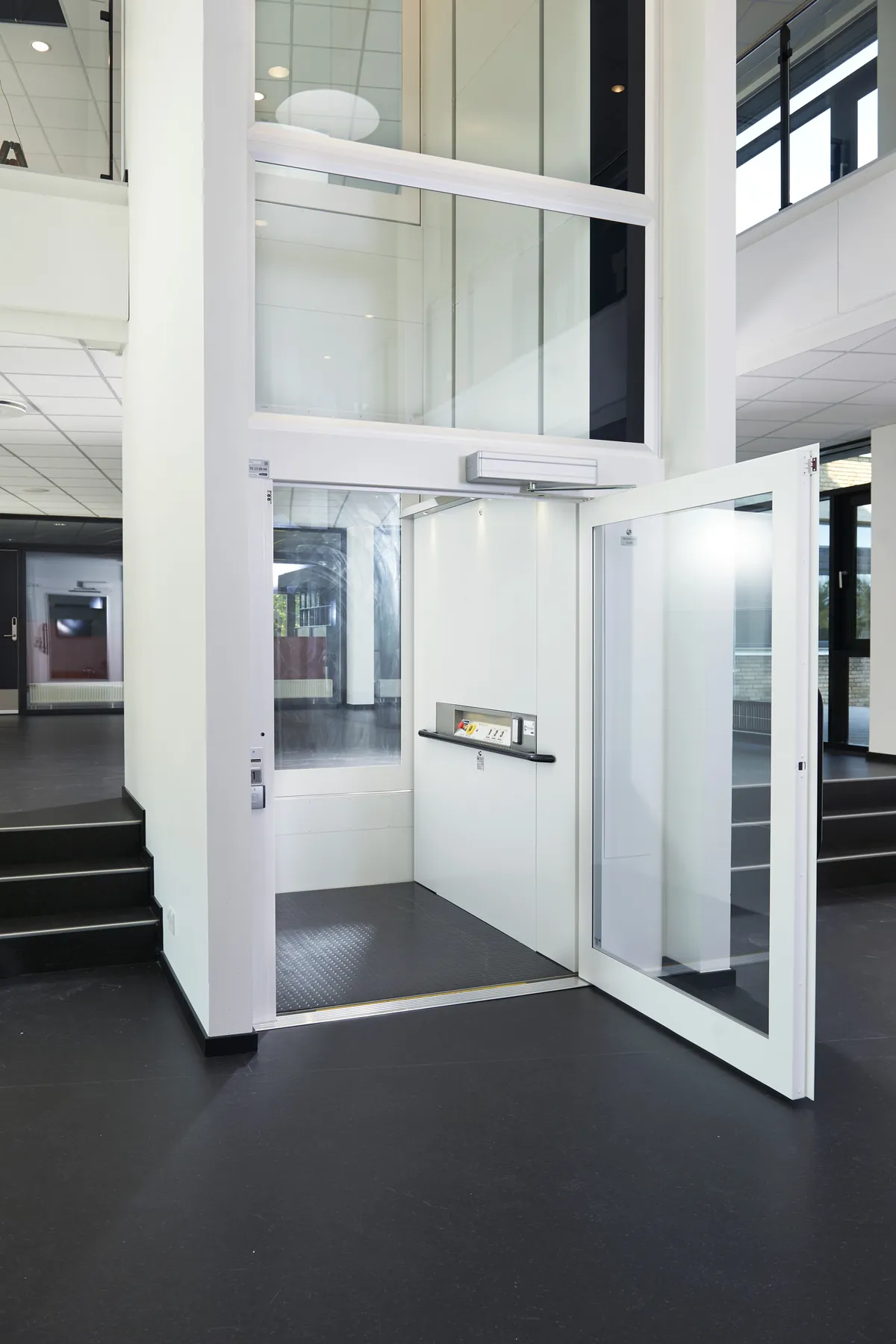 The ILS 1K at ground level with its swing door open onto the platform and control rail