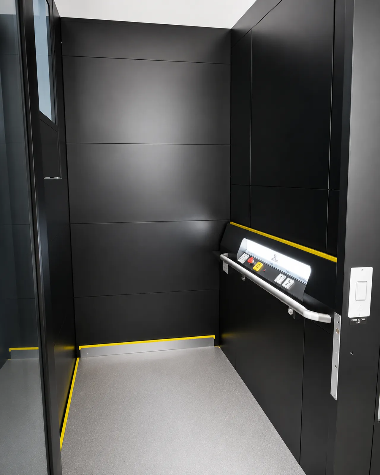 Lift platform interior with high-visibility yellow safety edges