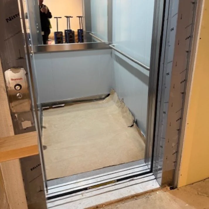 New lift cabin mid installation with protective film still in place